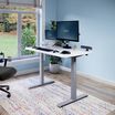 Electric Standing Desk with ComfortEdge in 48x30 White in raised position at home